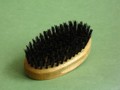 Oval-shaped natural hairbrush with boar bristle