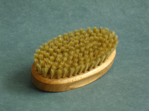 Oval-shaped natural hairbrush with bristles